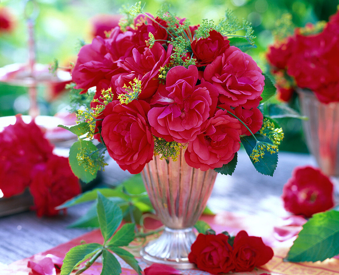 Bouquet of red rose, foeniculum in silver cup