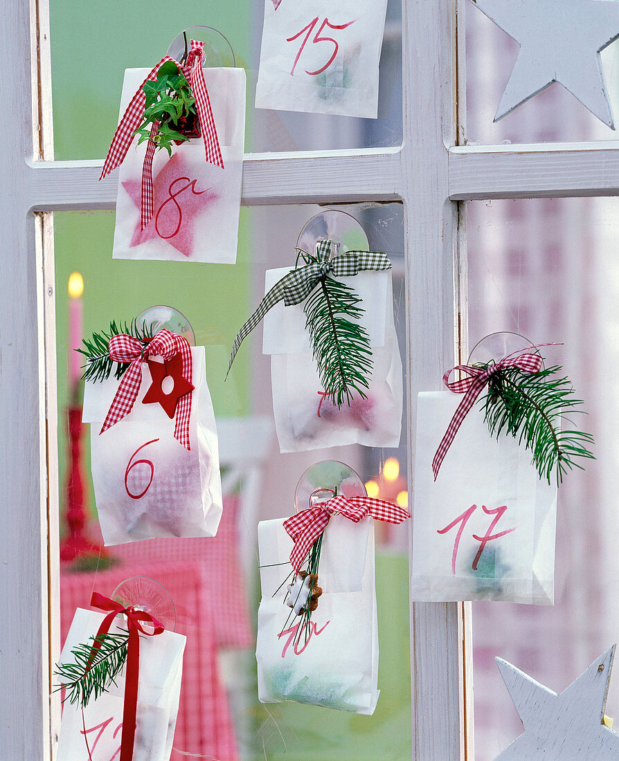 Advent calendar made of transparent paper bags with small gifts