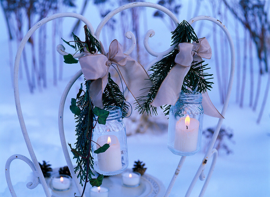 Screw jars as lanterns decorated with Pseudotsuga (Douglas fir)