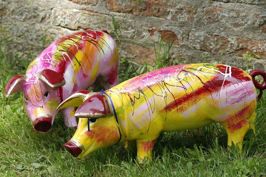 Colourful pigs as garden decoration