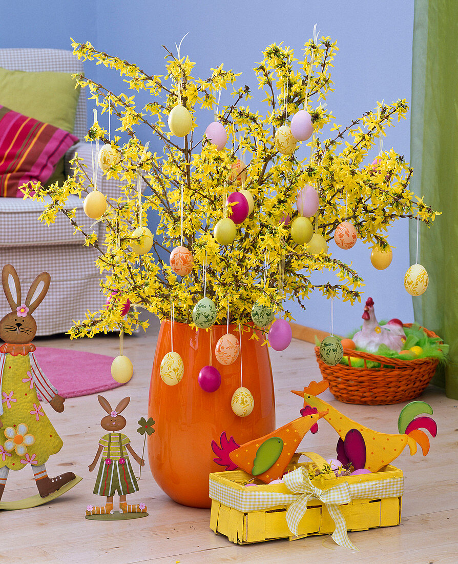 Forsythia (gold bells) bouquet decorated in orange vase