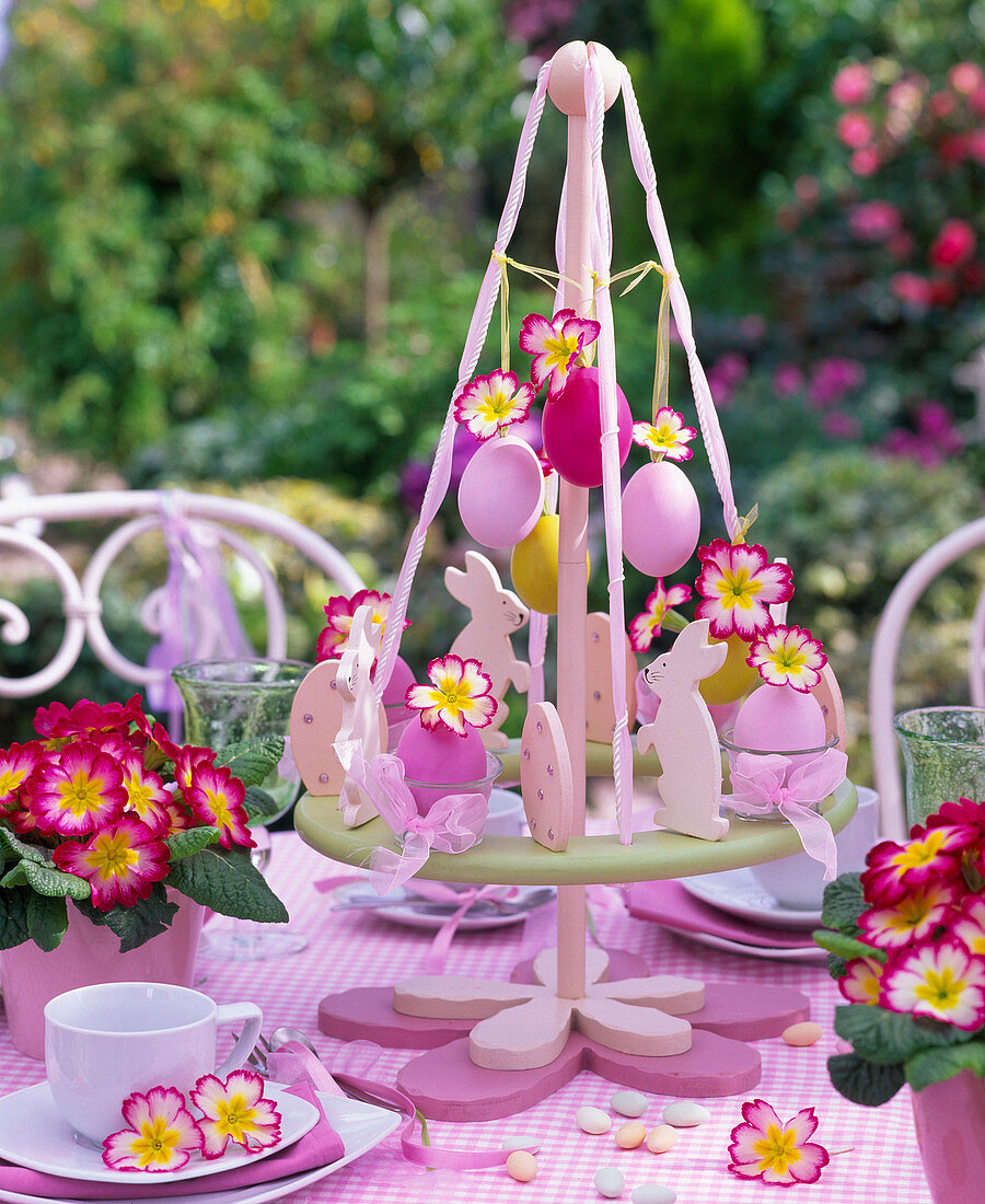 Footed Easter wreath decorated with primula flowers and easter eggs