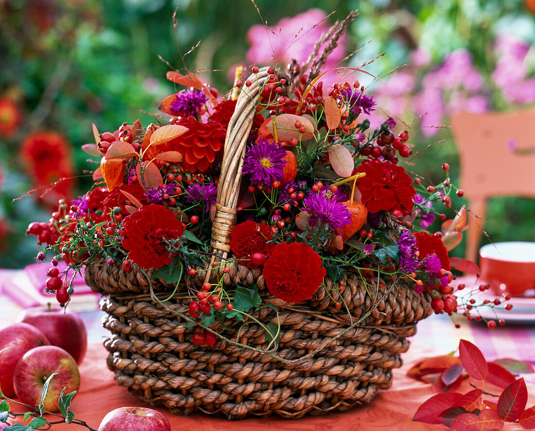 Arrangement of dahlia, aster, rose hips, autumn leaves