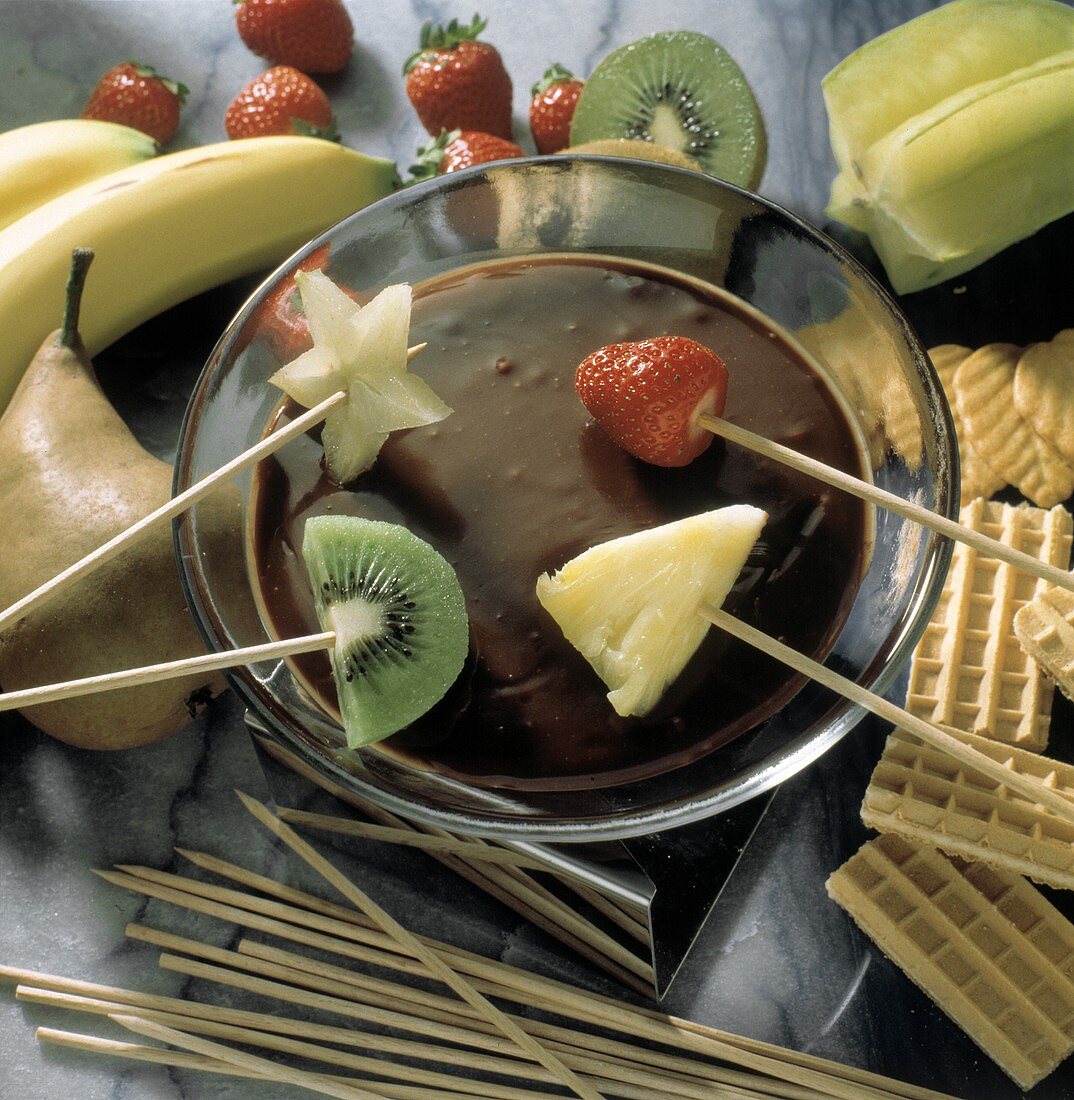 Dipping Assorted Fruit into Chocolate Fondue