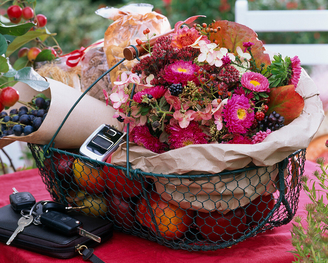 Shopping basket with bouquet of Callistephus (summer asters), Hydrangea