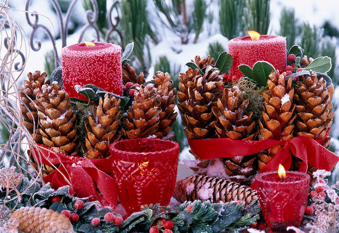 Red candles with spruce cones