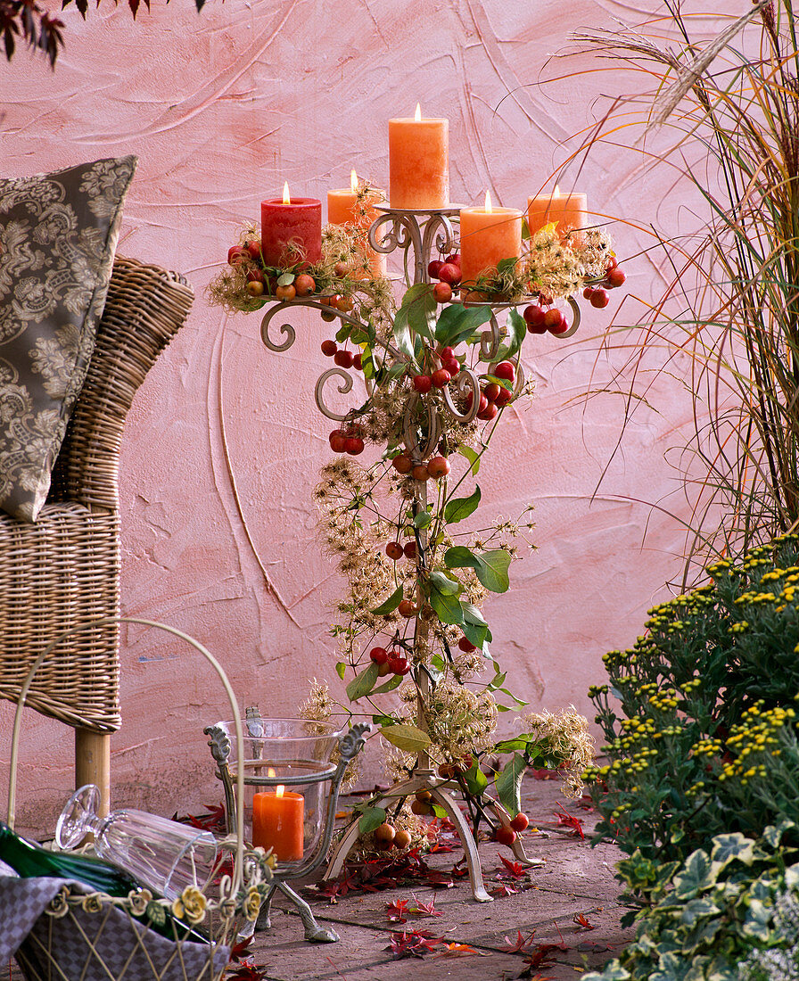 Candlesticks decorated with Clematis (woodland vine), Malus (ornamental apples)