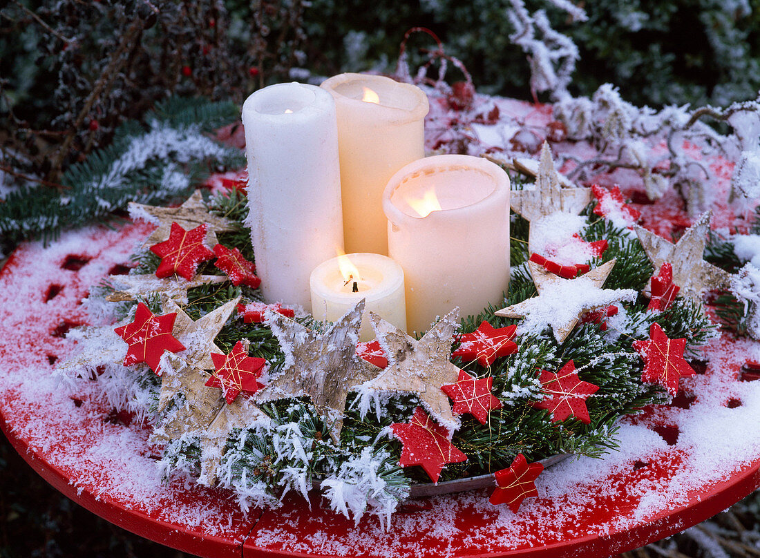 Advent wreath made of Abies (fir) with stars and white candles