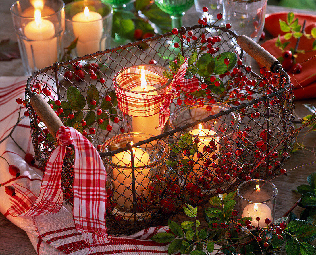 Paper lanterns in basket with pink (rose branches and rose hips), ribbon