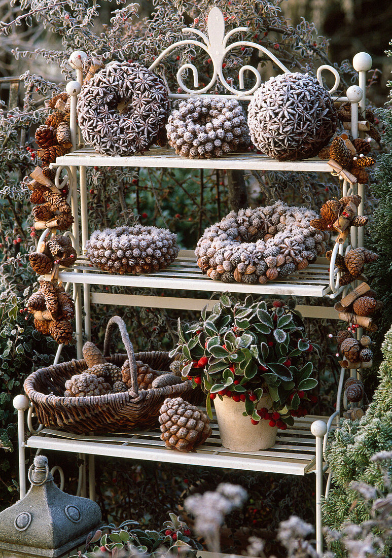 Wreaths and balls with larix cones, star anise, basket with pinus