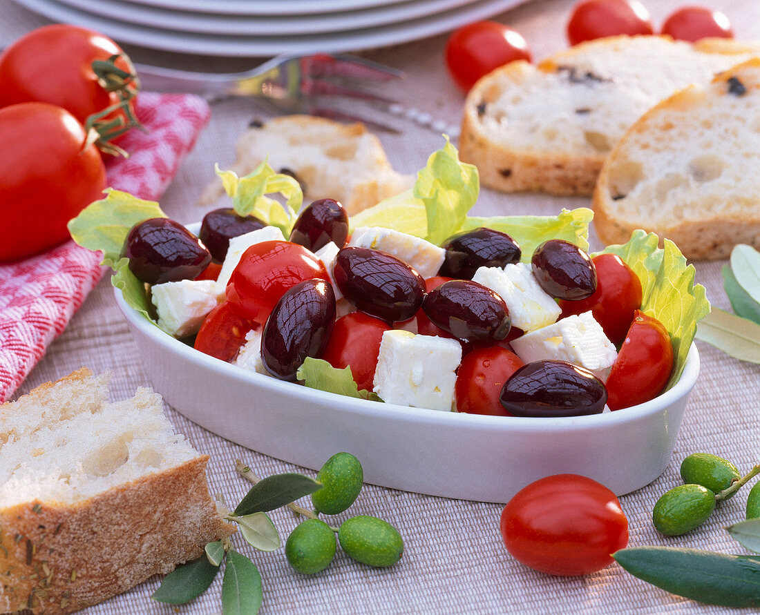 Greek salad with Olea (olives), Lycopersicon (tomatoes), Lactuca