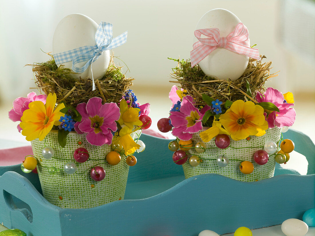 Breakfast eggs with ribbons in small nests of moss and hay