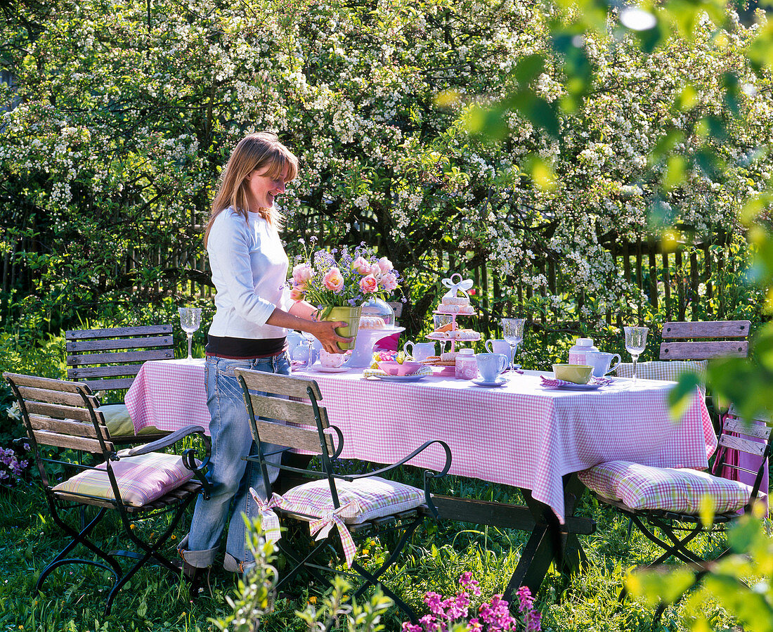 Table laid before blooming malus (apple tree)