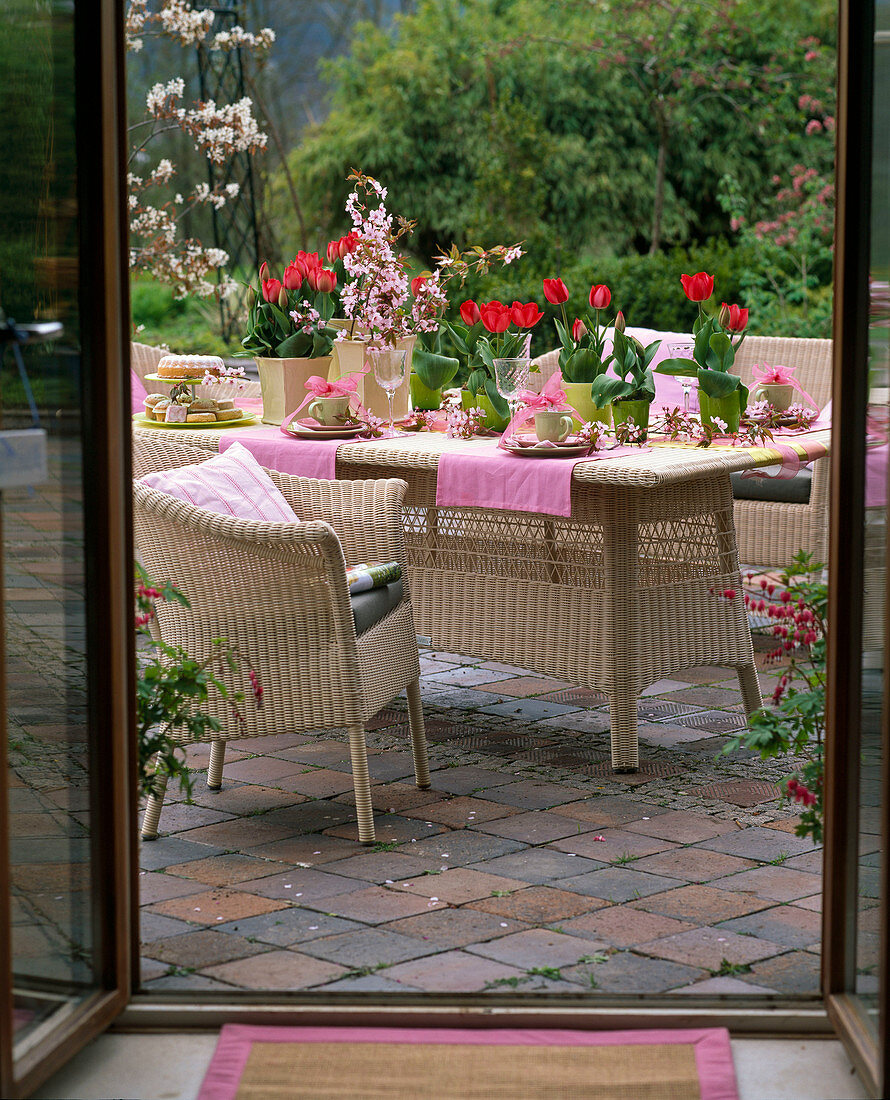 Table decoration with tulips and ornamental cherry blossoms