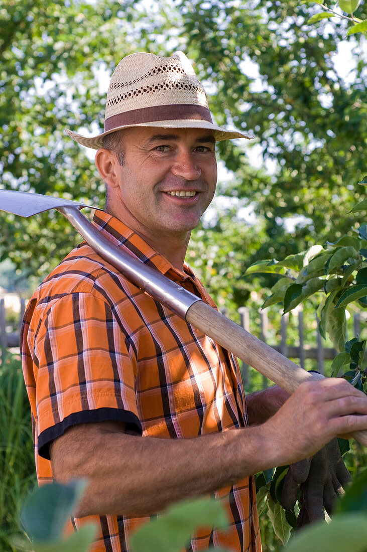 Man with spade over his shoulder