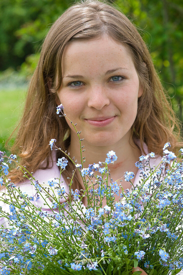 Frau mit Strauß aus Myosotis (Vergißmeinnicht)