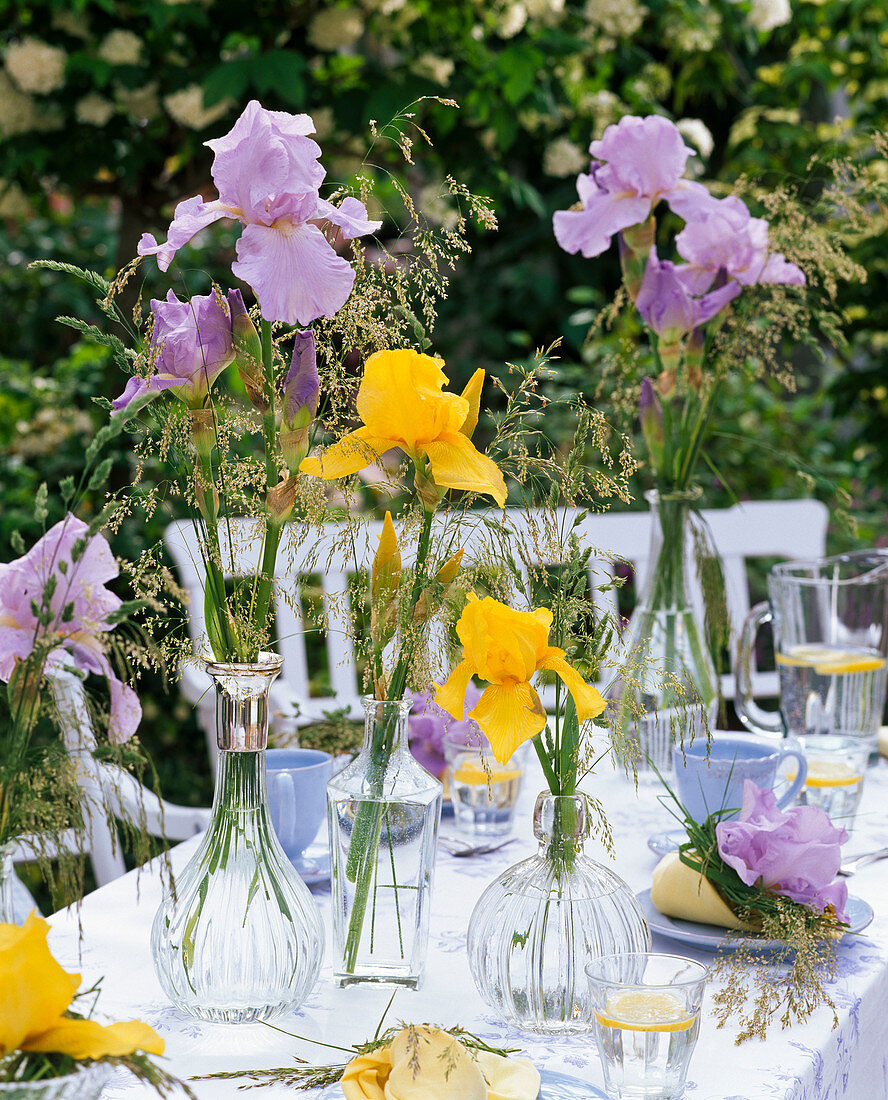 Table decoration with irises and grasses, blue place settings