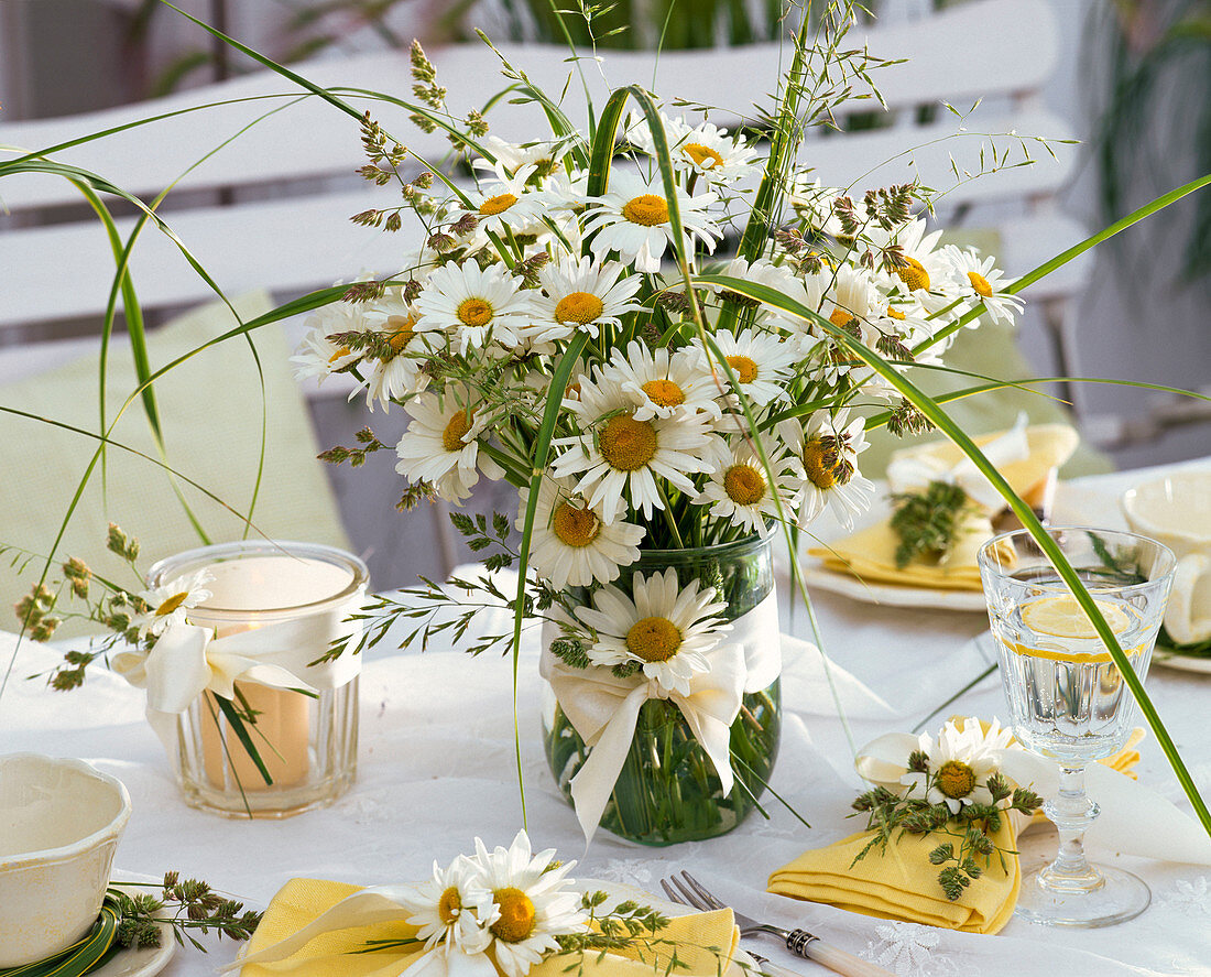 Table decoration with daisies and grasses