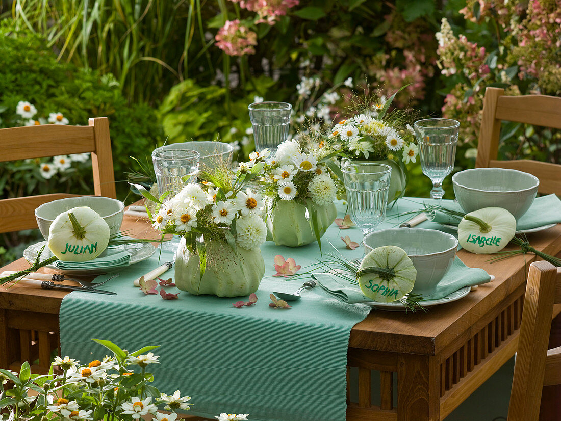 White table decoration with Cucurbita (ornamental pumpkin) as vase: Zinnia