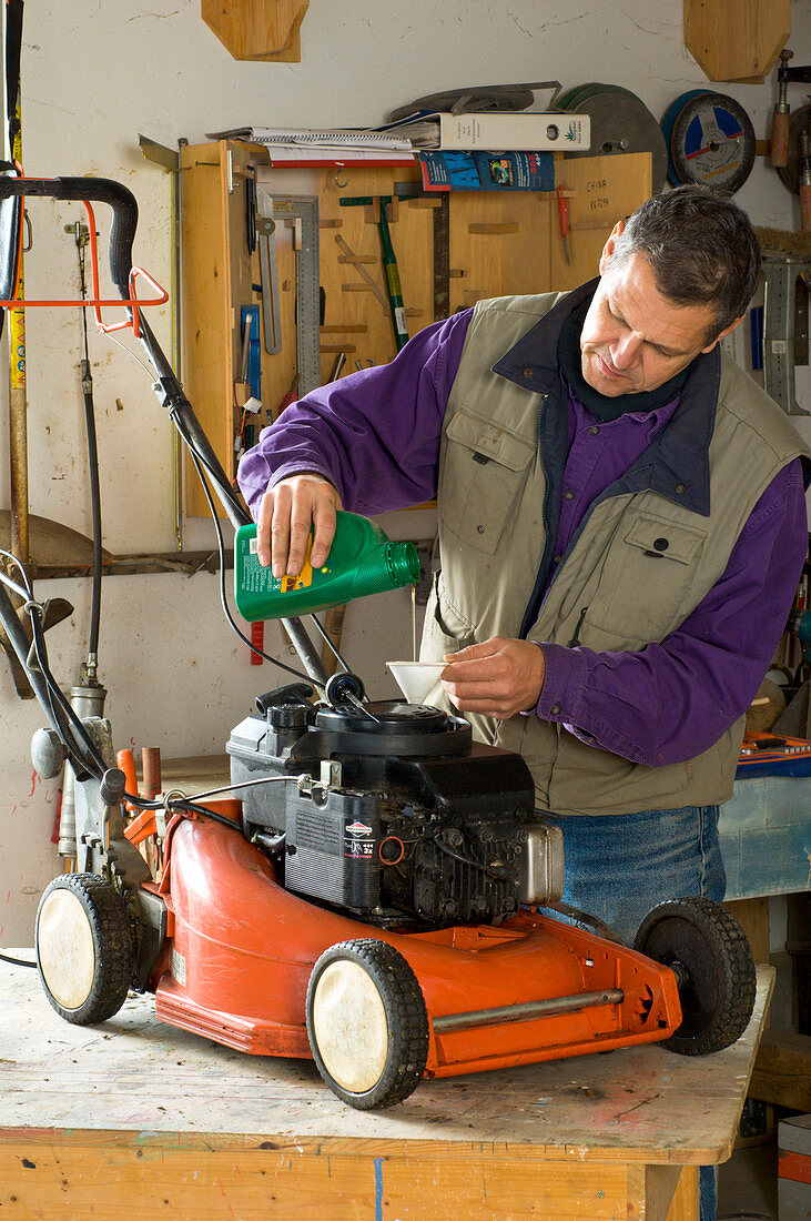 Man maintains lawnmower