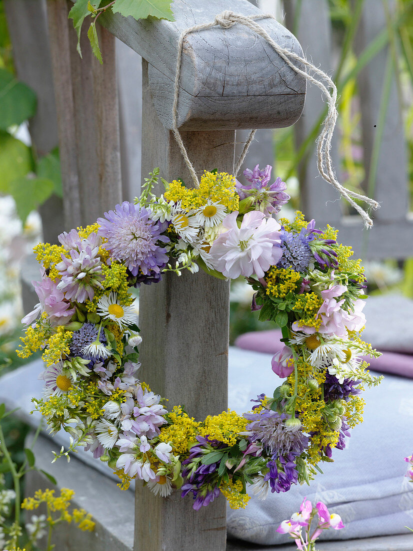 Small wildflowers wreath hanged on armrest