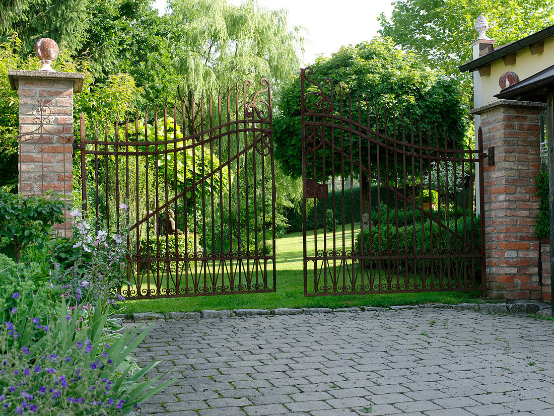 Garden view through wrought-iron gate