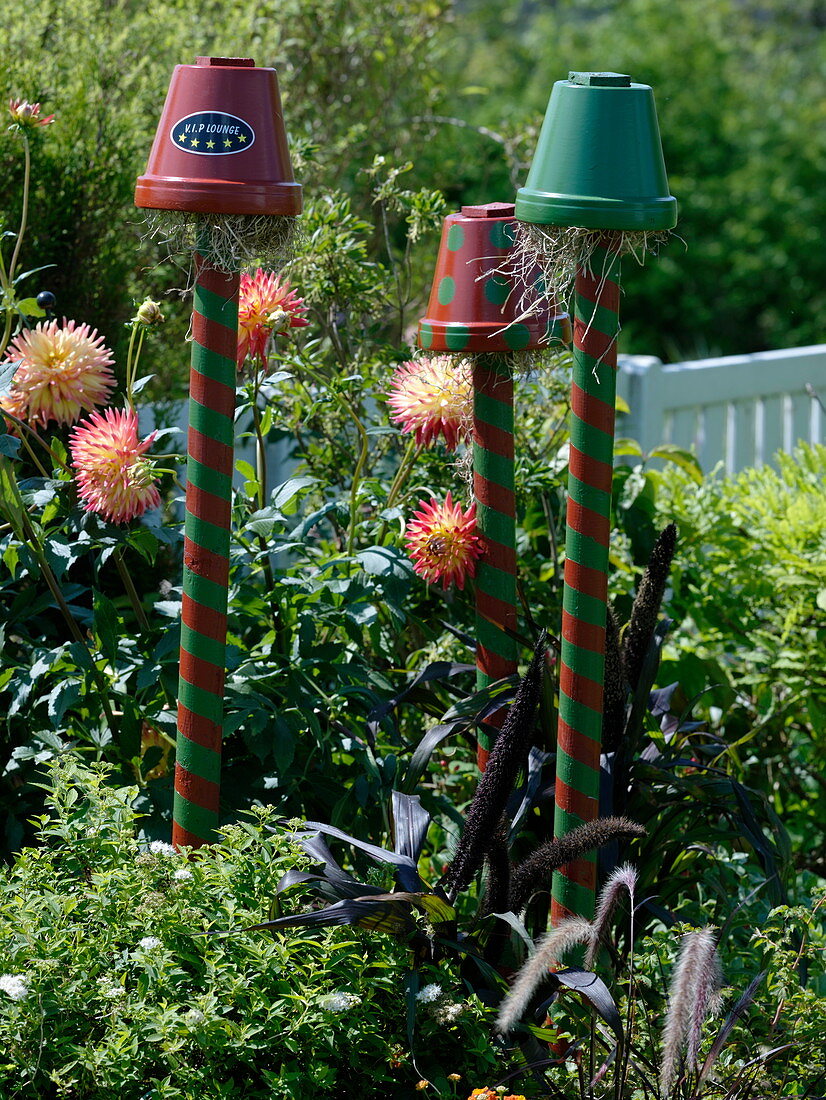 Colorfully painted clay pots on piles as beneficial shelter