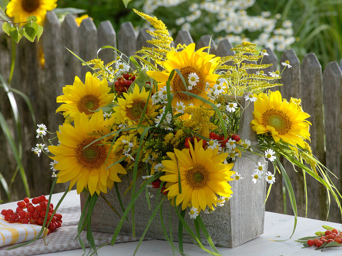 Late summer arrangement in wooden carrier