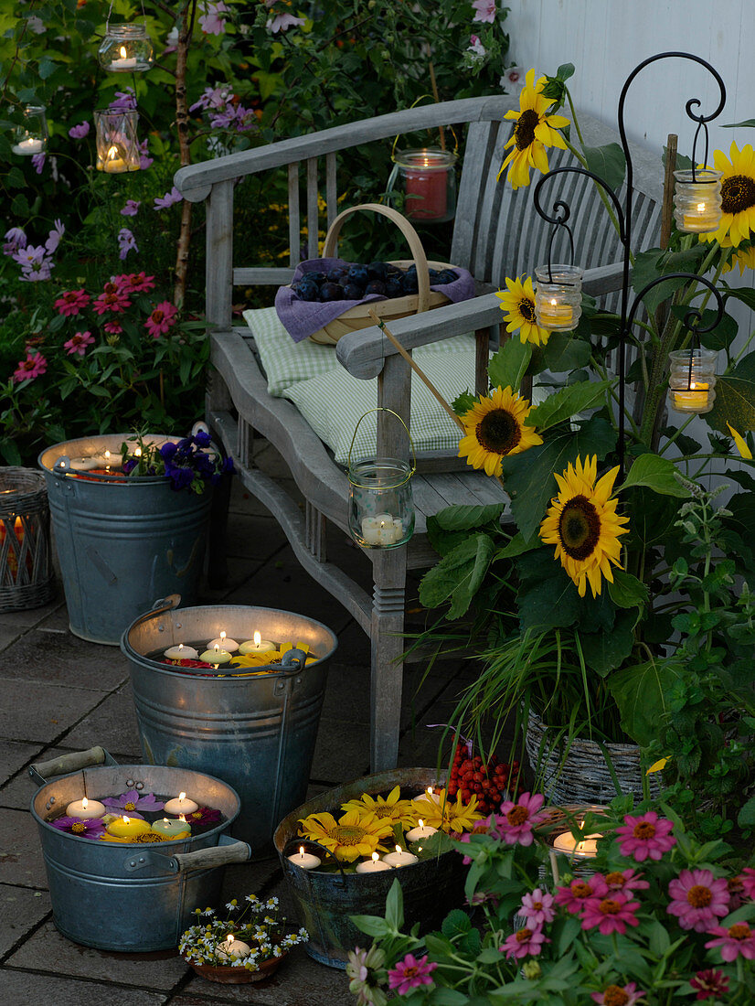 Evening terrace with summer flowers and candlelight