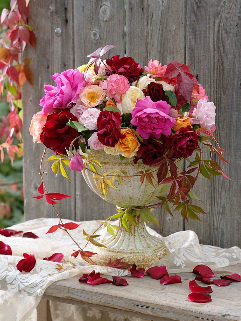 Bouquet of roses in iron vessel with foot