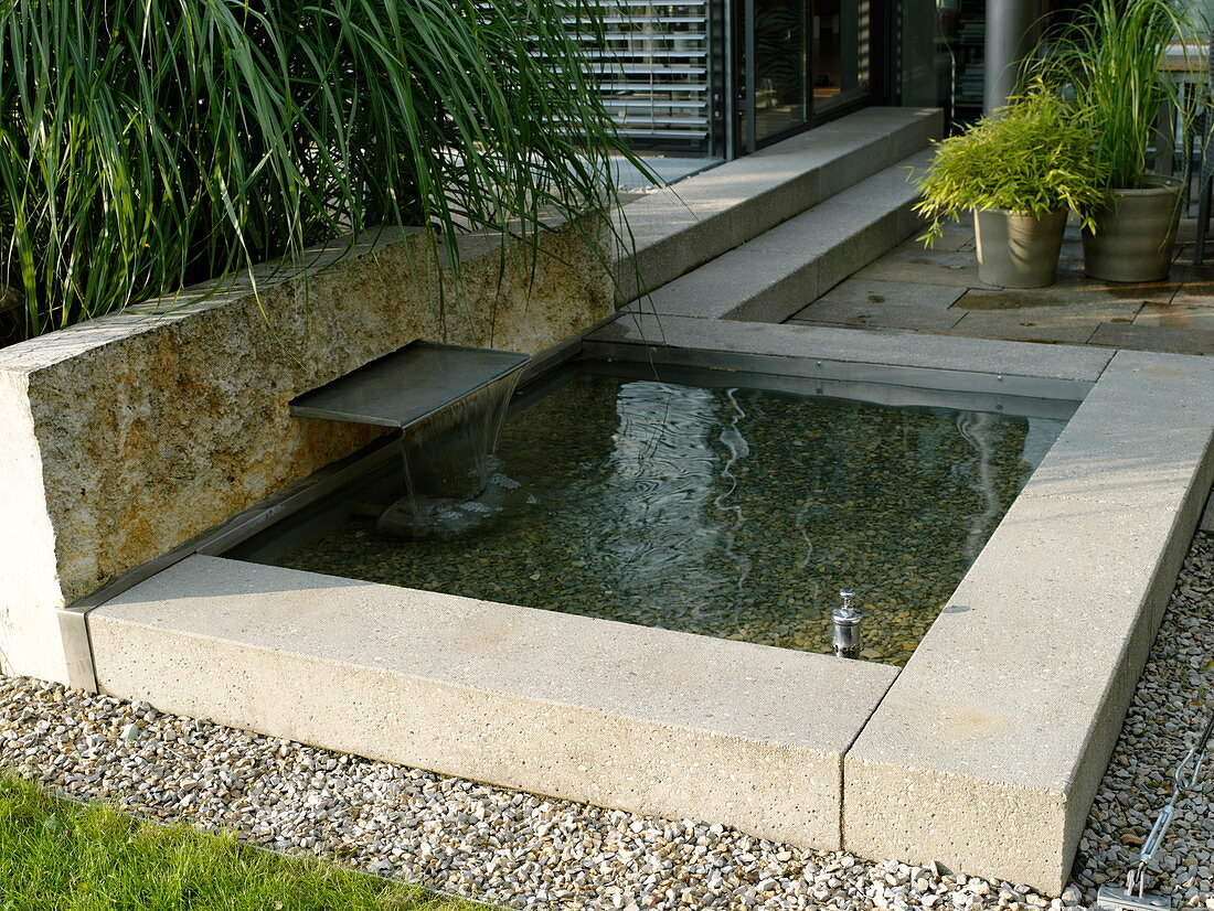 Small architectural pond with water feature