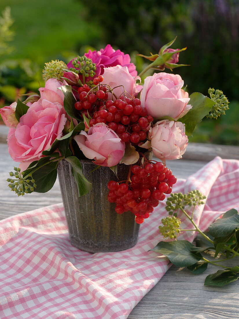 Bouquet with pink roses, snowball berries and ivy