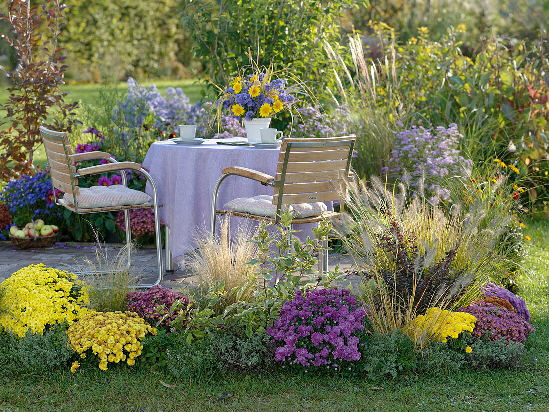 Patio on the terrace, bordered with colorful autumn bed