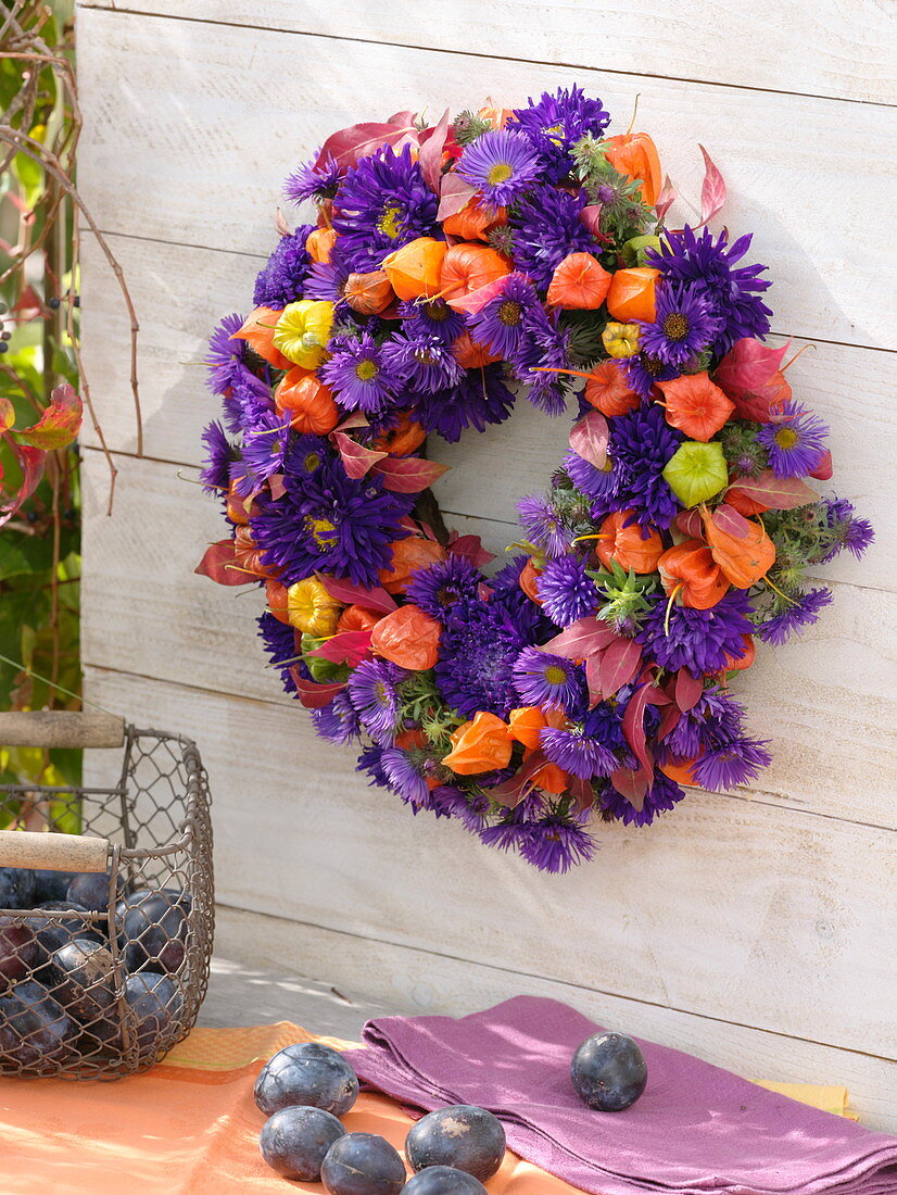 Hanging wreath of blue callistephus and physalis