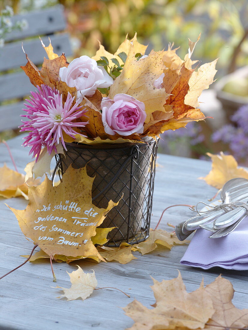 Wire cob with clay pot filled with leaves and flowers