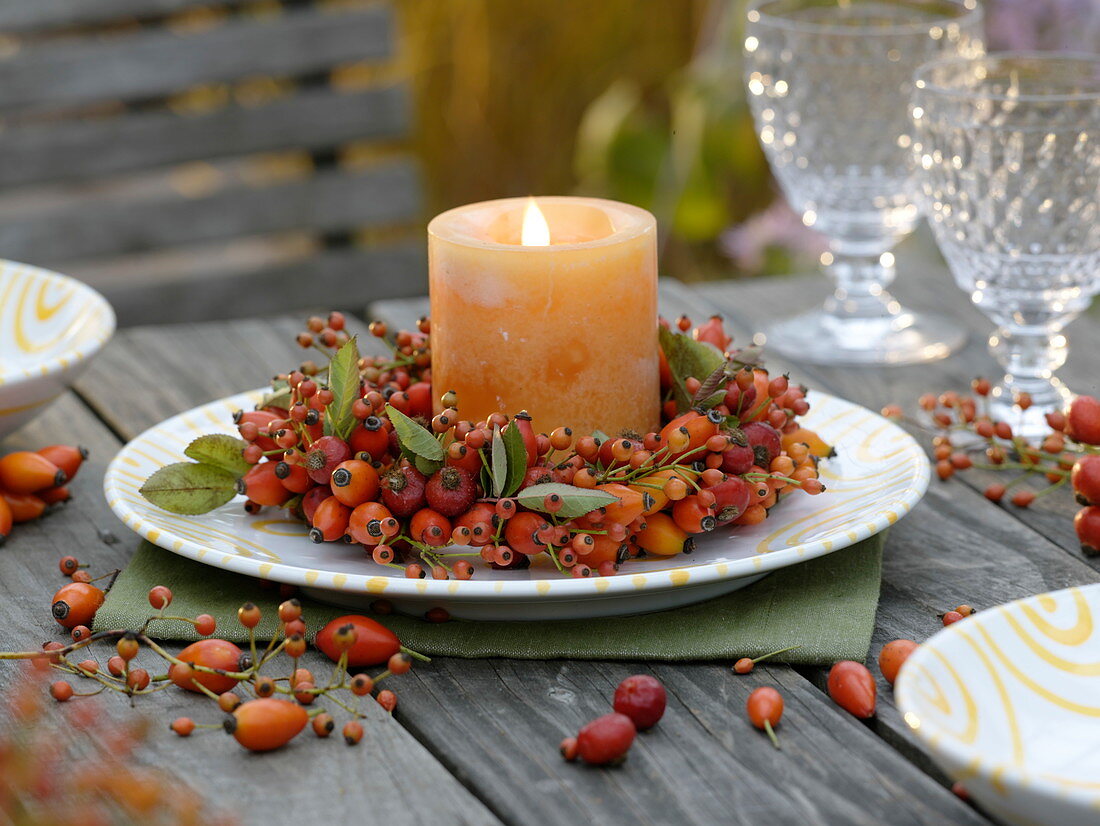 Wreath of rose hips with orange candle