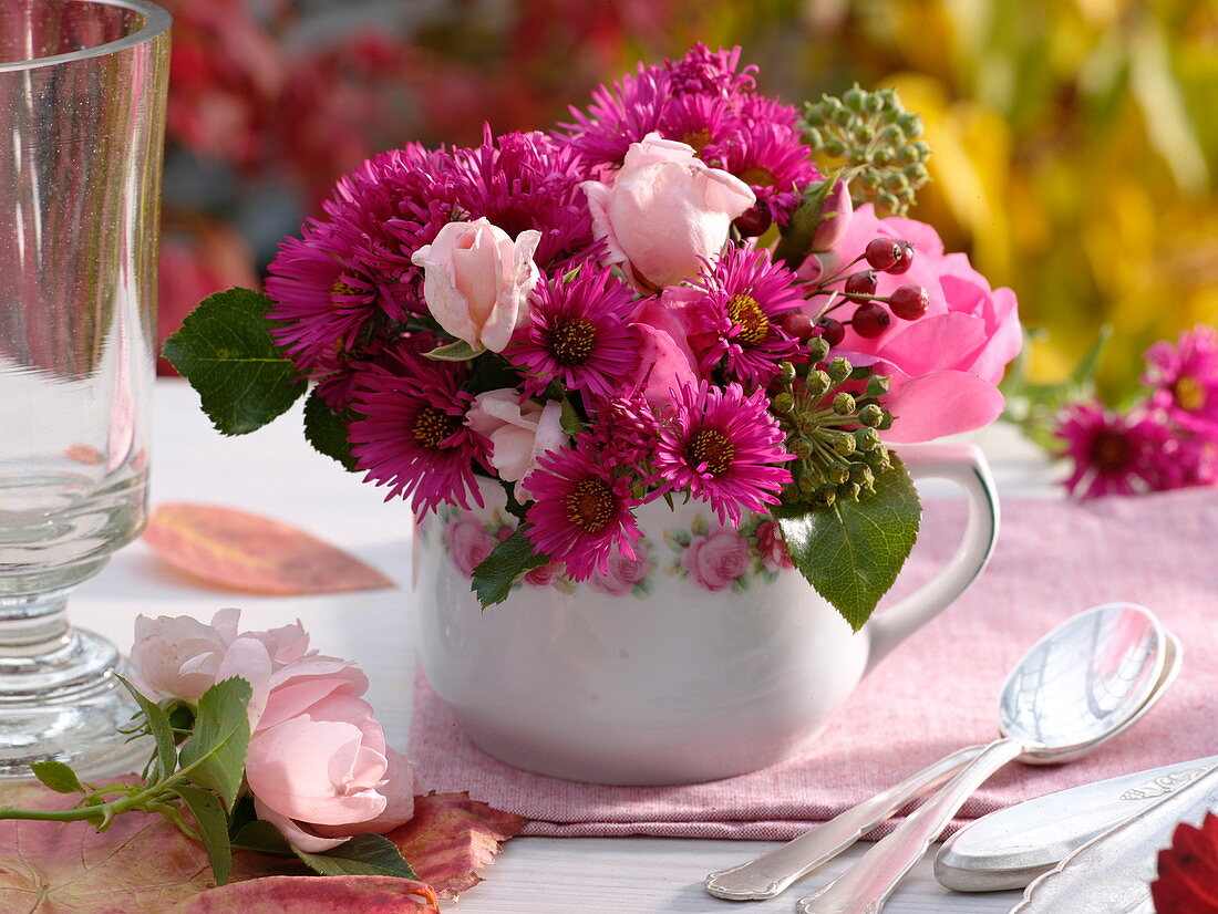 Bouquet with roses and asters in a small porcelain cup