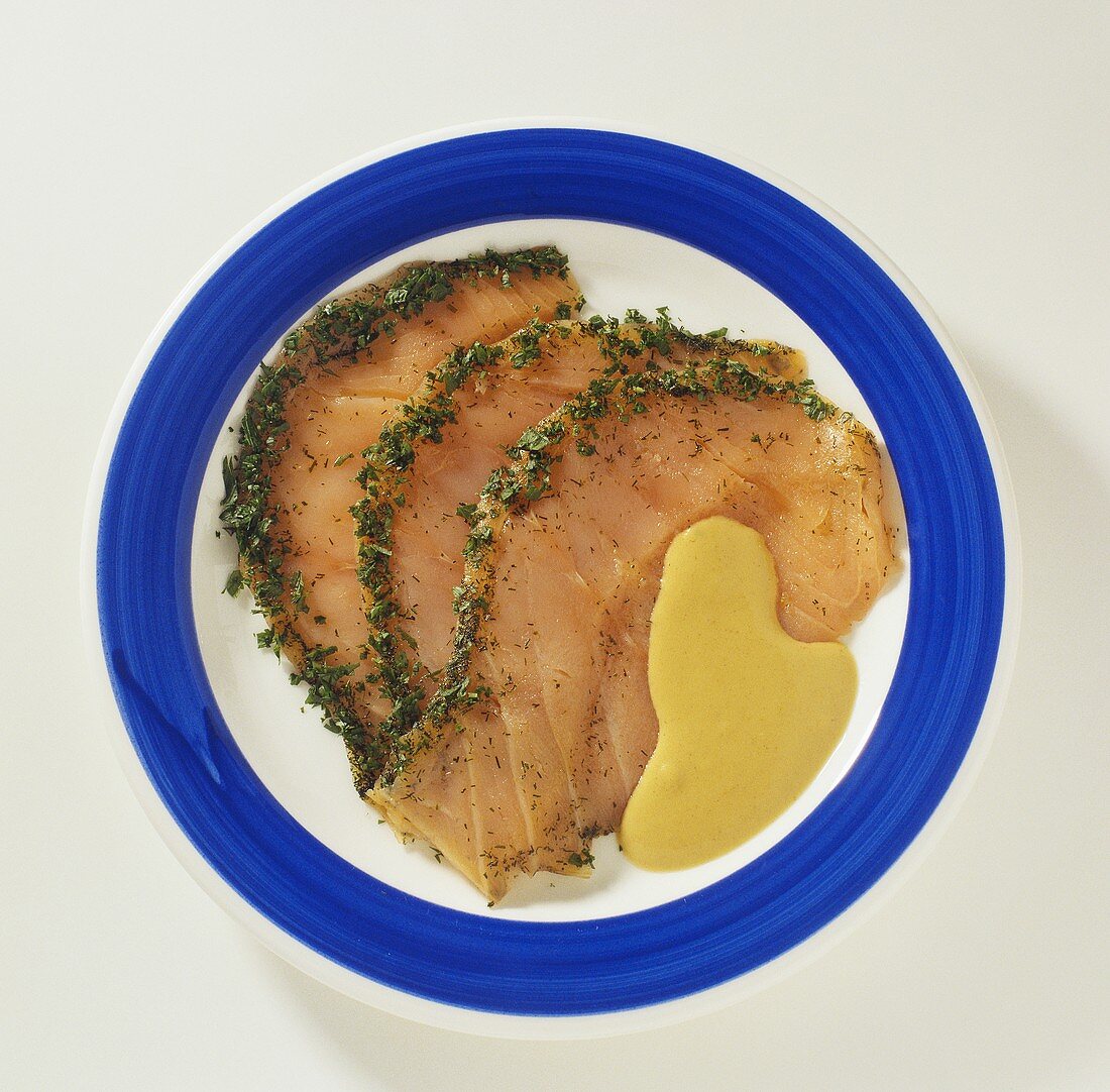 Slices of smoked salmon with mustard sauce
