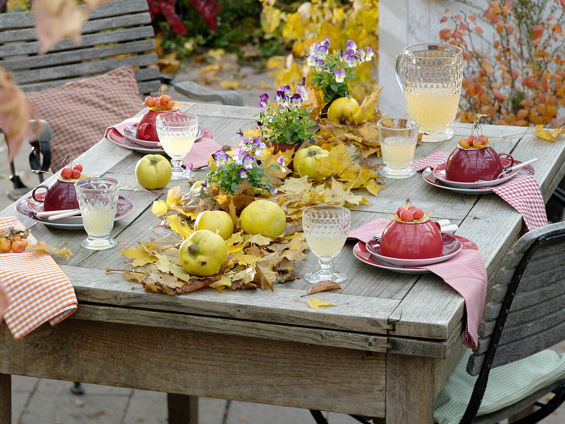 Table decoration with quinces on a carpet of foliage