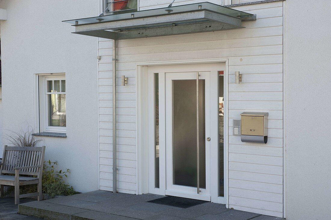 White front door with granite slab landing