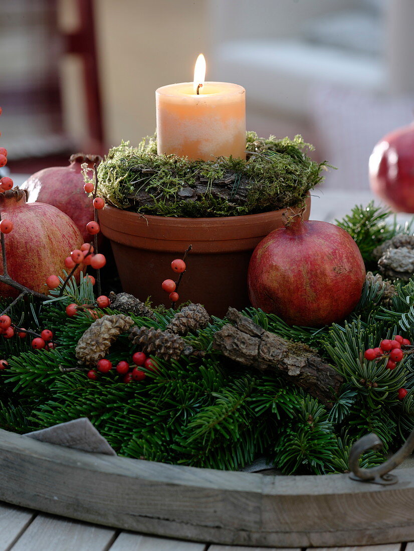 Candle in a clay pot with a moss-bark wreath