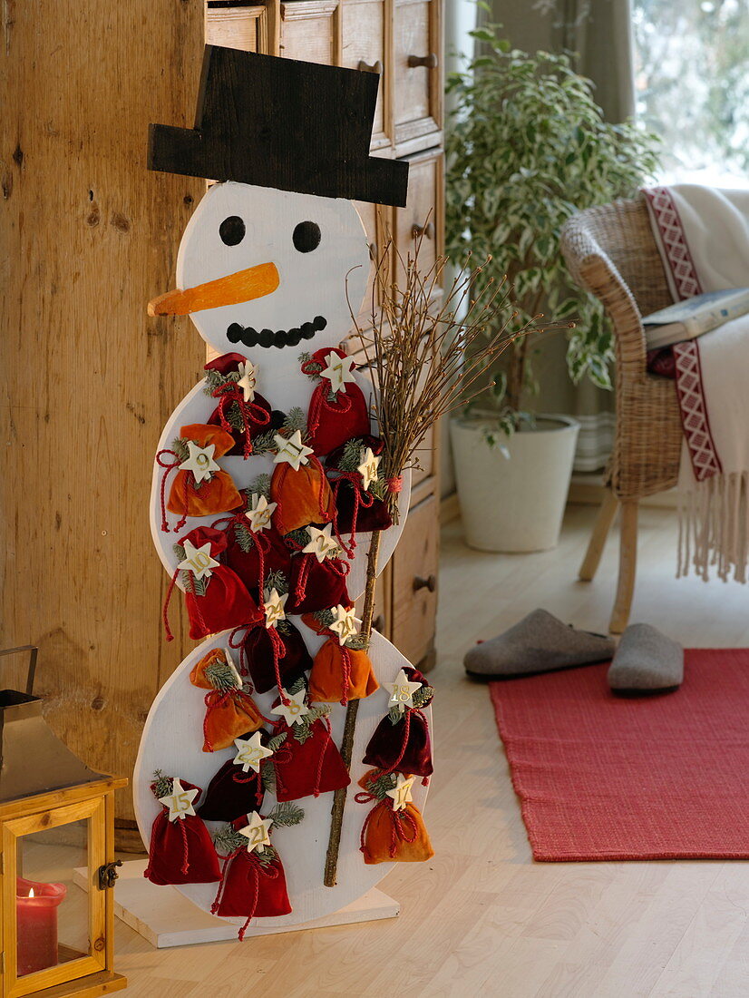 Self-made snowman as Advent calendar with numbered bags