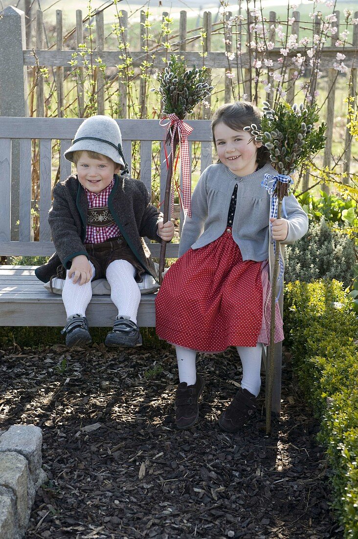 Children with palm bouquets in the cottage garden