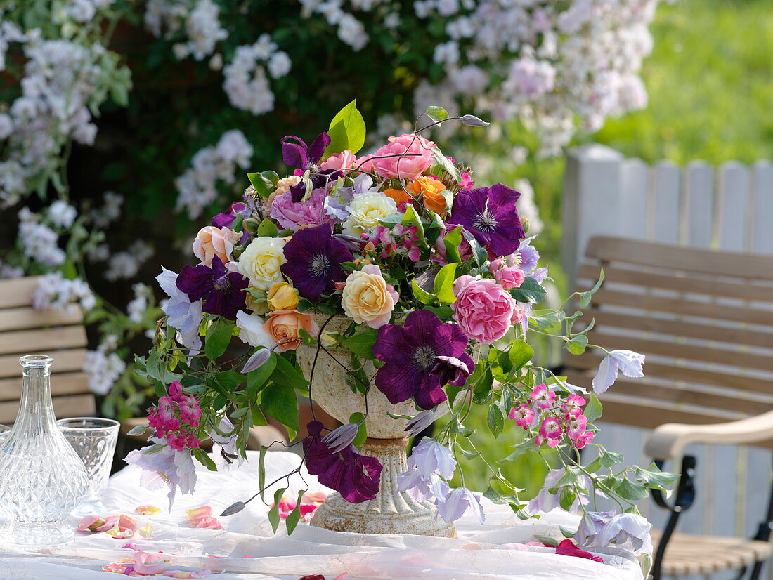 Romantic arrangement made of roses and clematis (clematis)