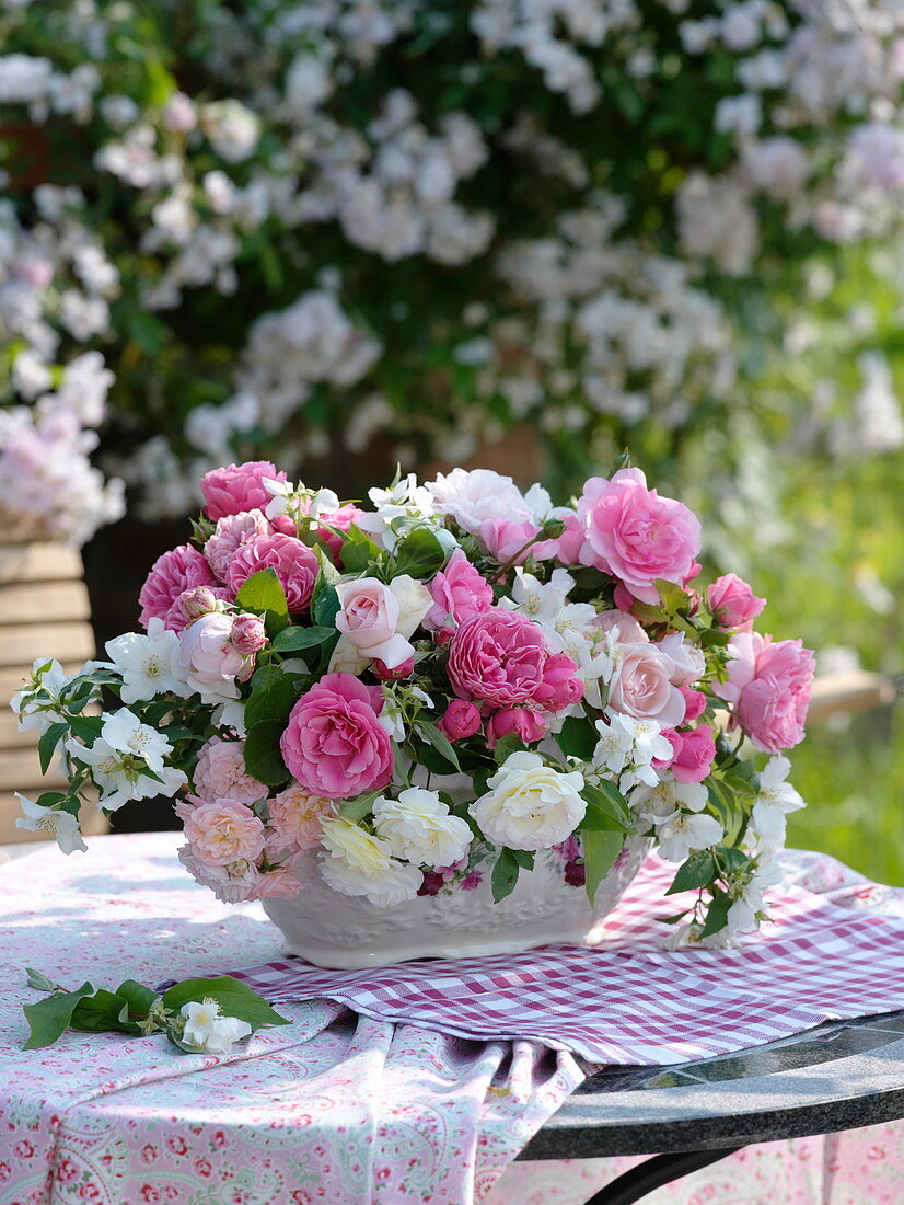 Pink and white scent of roses and Philadelphus coronarius