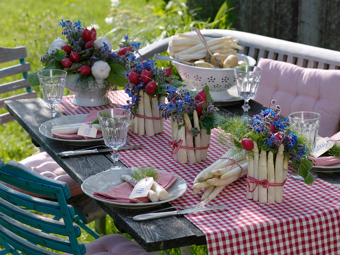 Table decoration with asparagus, radishes and borage