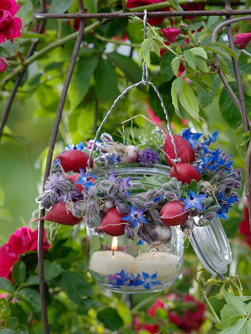 Preserving jar with vegetable and herb wreath hung as a lantern