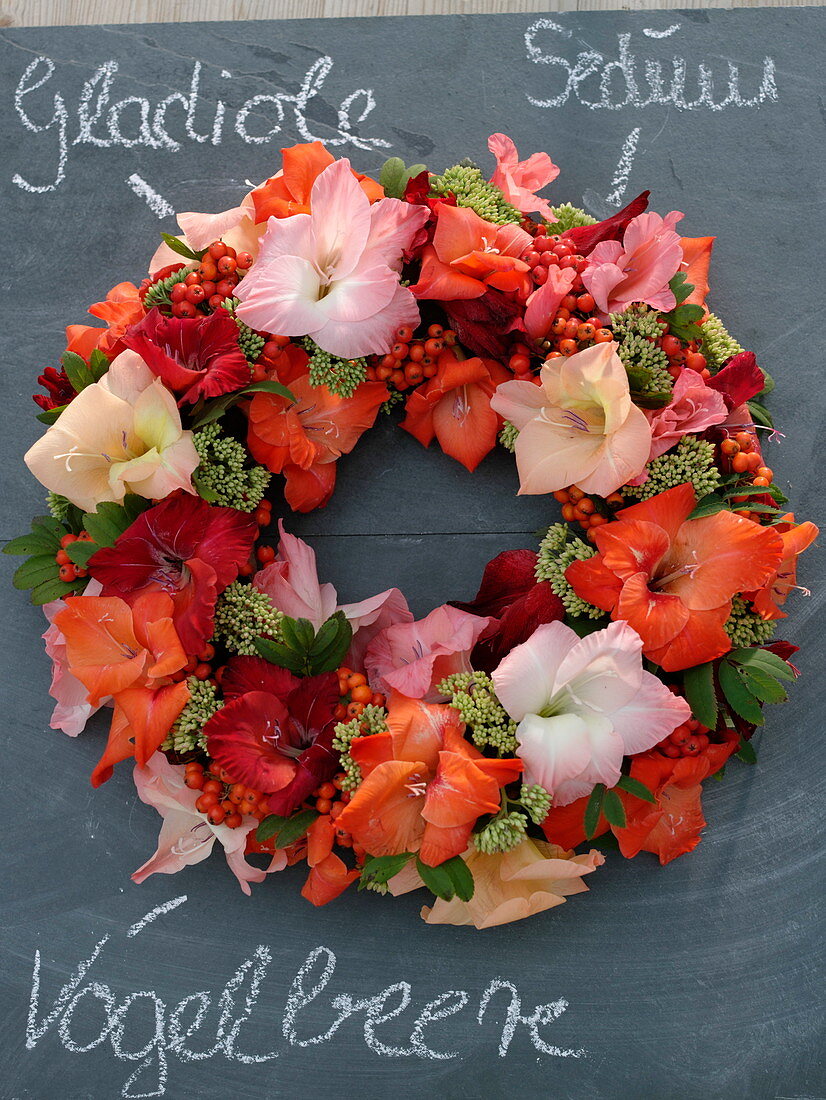 Late summer wreath of Gladiolus (gladioli), Sorbus (rowan berries)