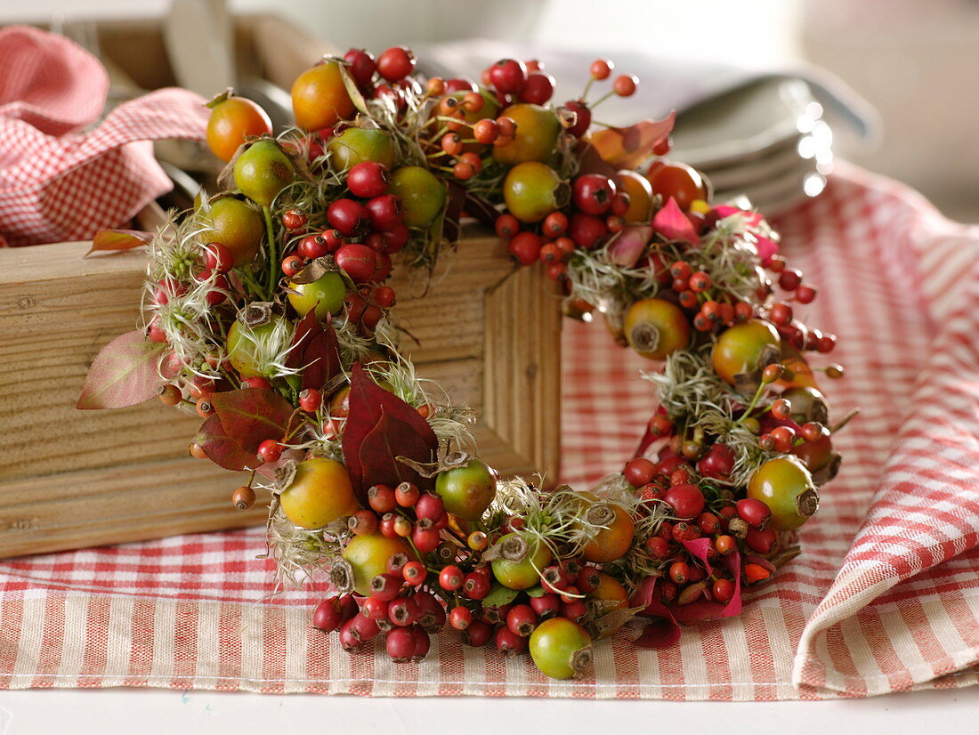 Autumn wreath: pinks (rose hips), clematis (woodland vine seed stalks)