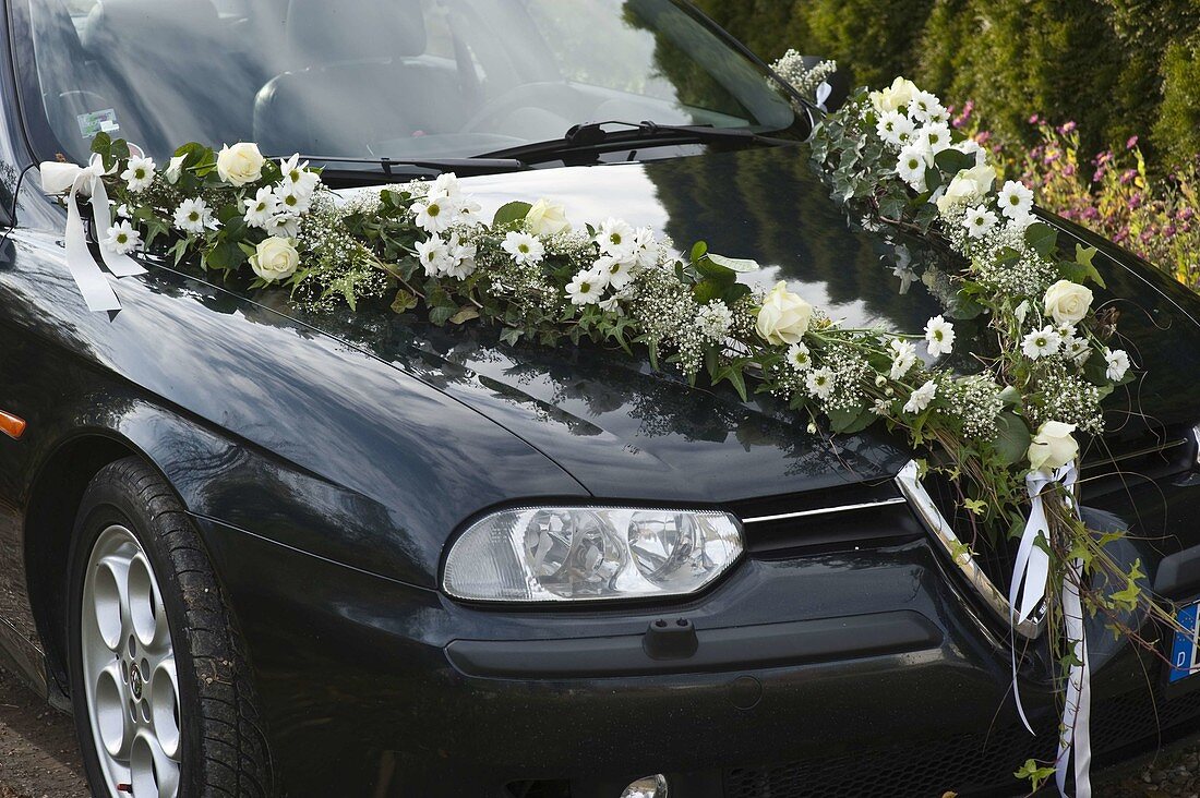 Bridal car with garland on bonnet